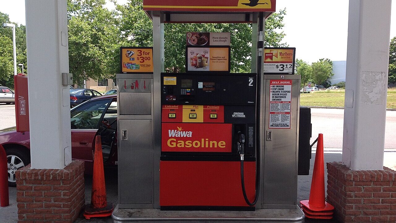 Modern petrol station pump showing unleaded, plus and premium fuel prices