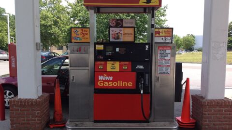 Modern petrol station pump showing unleaded, plus and premium fuel prices